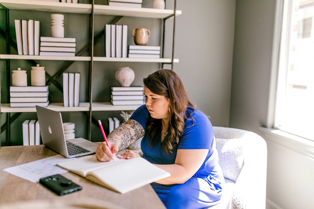 writer at desk with notebook