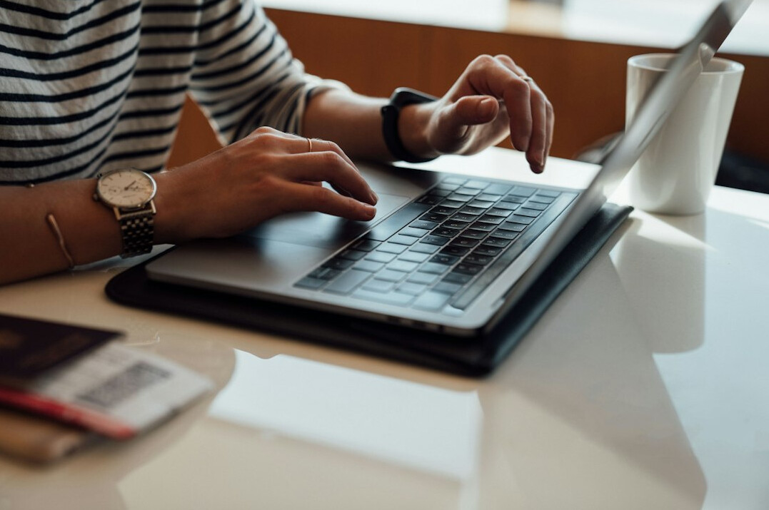 writer typing on laptop